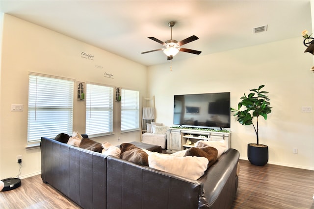 living room with ceiling fan and dark hardwood / wood-style floors