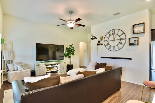 living room featuring ceiling fan and hardwood / wood-style floors