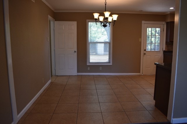 unfurnished dining area featuring ornamental molding, a wealth of natural light, a chandelier, and light tile patterned floors