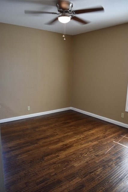 unfurnished room with ceiling fan and dark hardwood / wood-style flooring