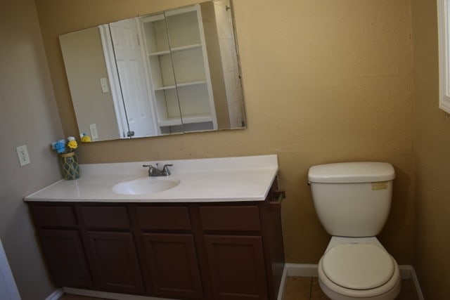 bathroom featuring vanity and toilet