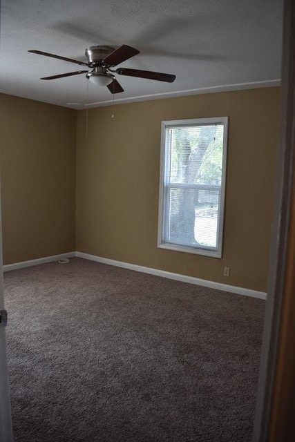 carpeted empty room with a textured ceiling and ceiling fan