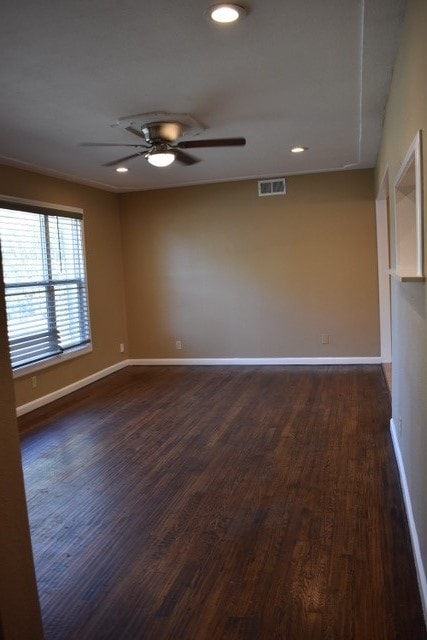 unfurnished room with ceiling fan and dark hardwood / wood-style floors