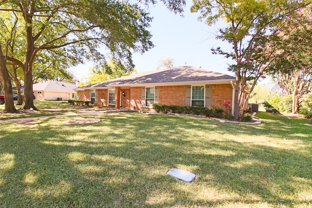 rear view of property featuring a yard and central AC unit