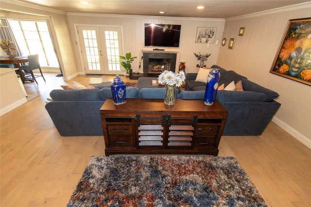 living room featuring ornamental molding, french doors, and light hardwood / wood-style flooring