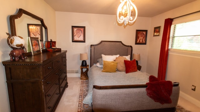 bedroom featuring a notable chandelier