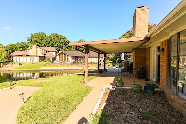 view of yard featuring a patio area and a water view