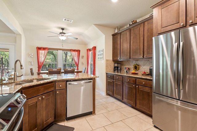 kitchen featuring ceiling fan, stainless steel appliances, sink, and a healthy amount of sunlight