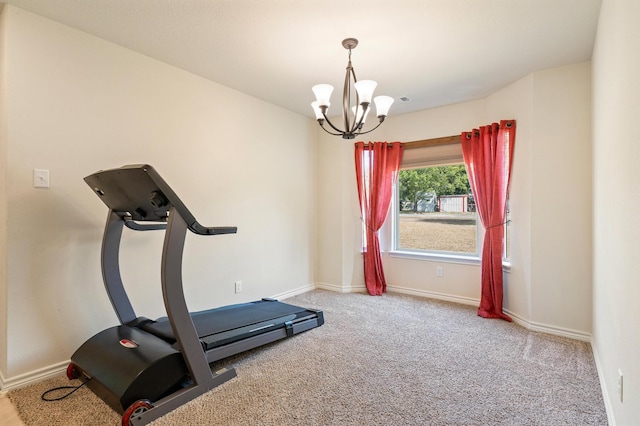 workout area with a chandelier and carpet flooring