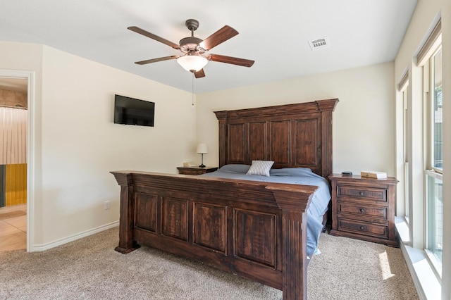 carpeted bedroom with ceiling fan and multiple windows