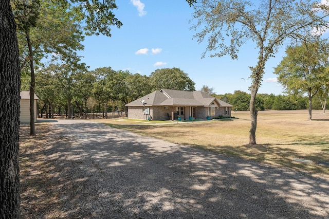 ranch-style home with a front yard