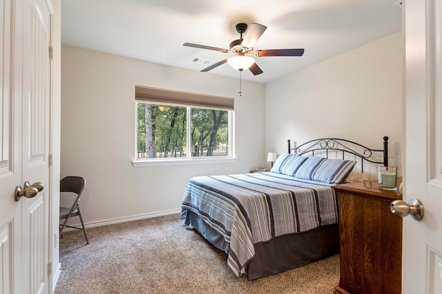 carpeted bedroom with ceiling fan and a closet