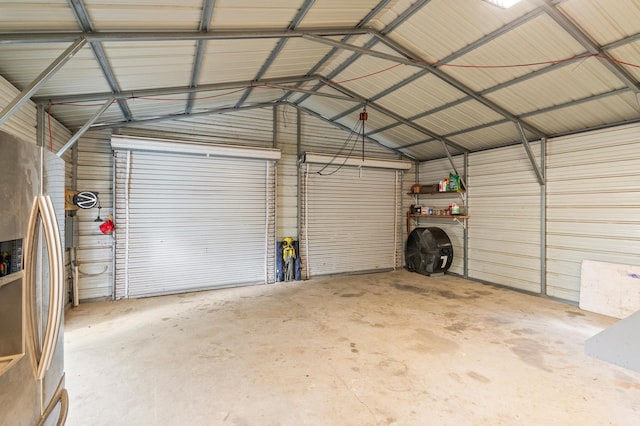 garage with stainless steel refrigerator with ice dispenser