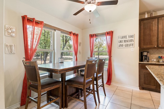 tiled dining room featuring ceiling fan