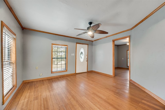 foyer featuring ornamental molding, light hardwood / wood-style floors, and ceiling fan