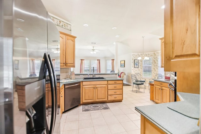 kitchen with stainless steel appliances, a sink, pendant lighting, a peninsula, and ceiling fan with notable chandelier
