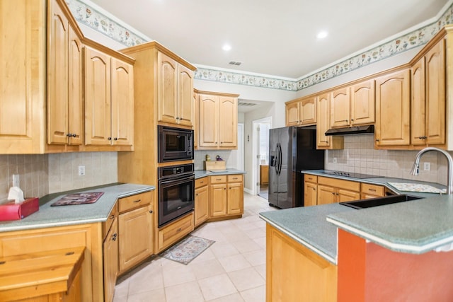 kitchen featuring light brown cabinetry, a sink, black appliances, under cabinet range hood, and light tile patterned floors