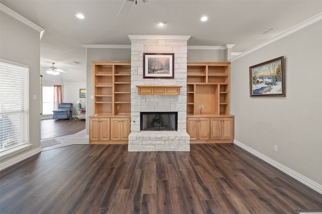 unfurnished living room featuring dark hardwood / wood-style flooring, crown molding, a fireplace, and ceiling fan