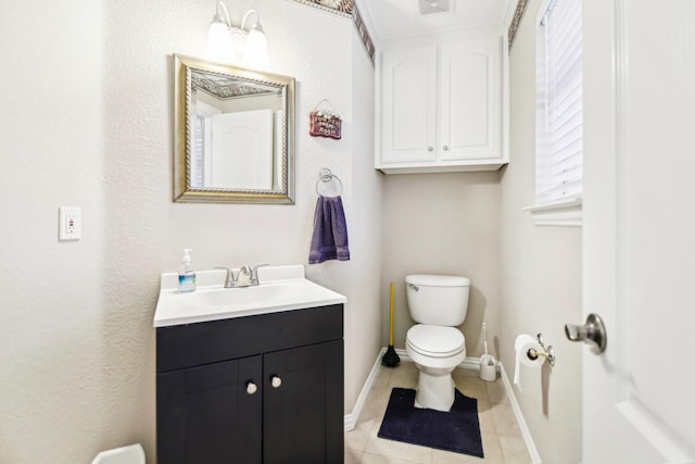 bathroom with tile patterned flooring, visible vents, toilet, vanity, and baseboards