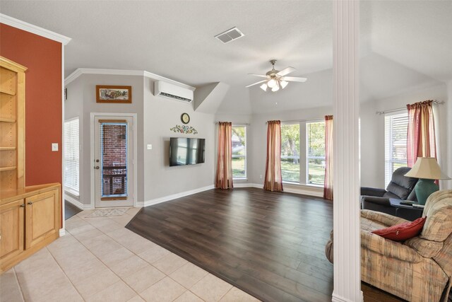 living room featuring ornamental molding, a wall mounted AC, ceiling fan, light tile patterned floors, and lofted ceiling