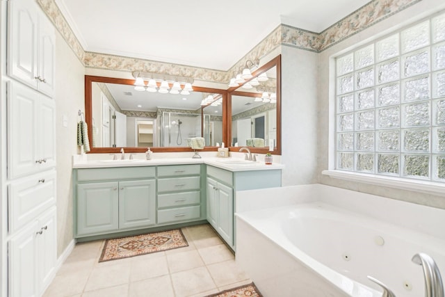 full bathroom with double vanity, a tub with jets, a stall shower, and a sink