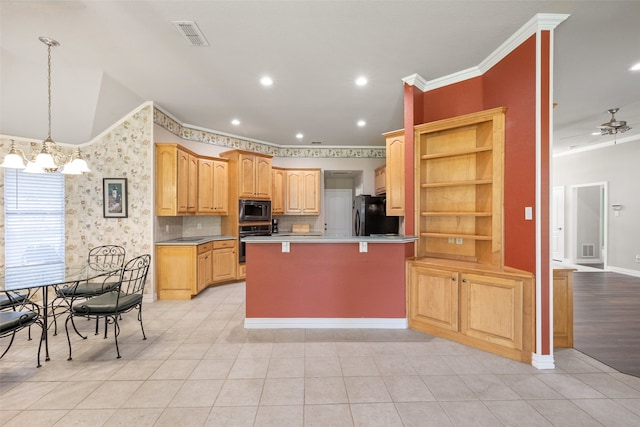 kitchen featuring crown molding, a kitchen bar, a kitchen island, black appliances, and ceiling fan with notable chandelier