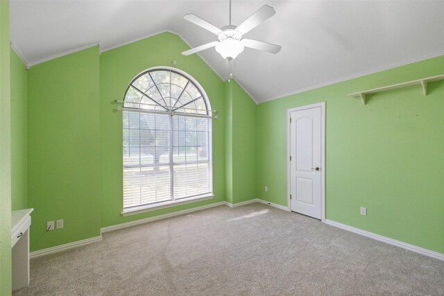 carpeted empty room featuring vaulted ceiling and ceiling fan