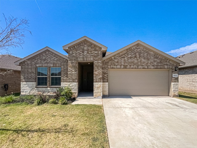 view of front of home with a garage and a front lawn