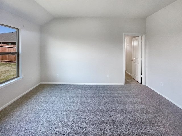 empty room with vaulted ceiling and carpet