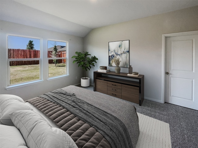 carpeted bedroom with lofted ceiling