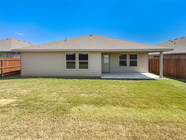 back of property featuring a patio area and a lawn