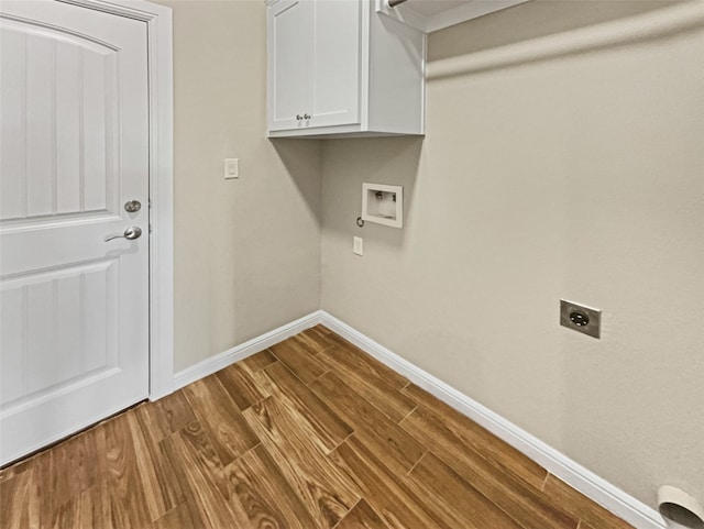 laundry room with hookup for a washing machine, wood-type flooring, hookup for an electric dryer, and cabinets