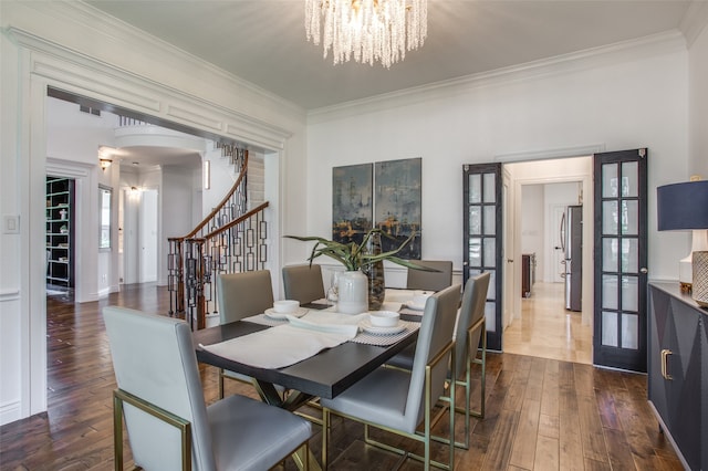 dining area with french doors, dark hardwood / wood-style floors, and ornamental molding