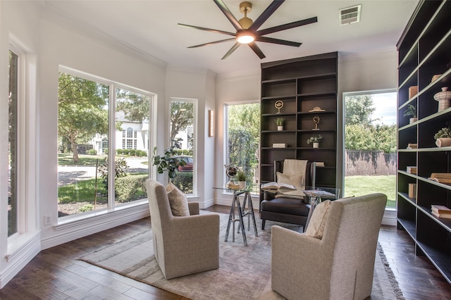 interior space featuring ceiling fan, dark wood-type flooring, and ornamental molding