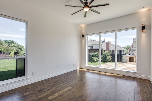 empty room featuring ceiling fan and dark wood-type flooring