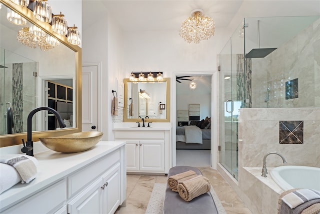 bathroom featuring ceiling fan, vanity, and shower with separate bathtub