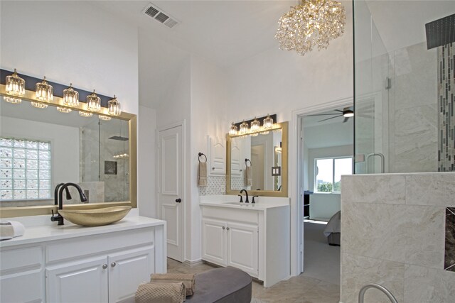 bathroom featuring walk in shower, vanity, ceiling fan, and lofted ceiling