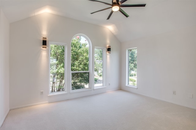 spare room featuring ceiling fan, light colored carpet, and lofted ceiling