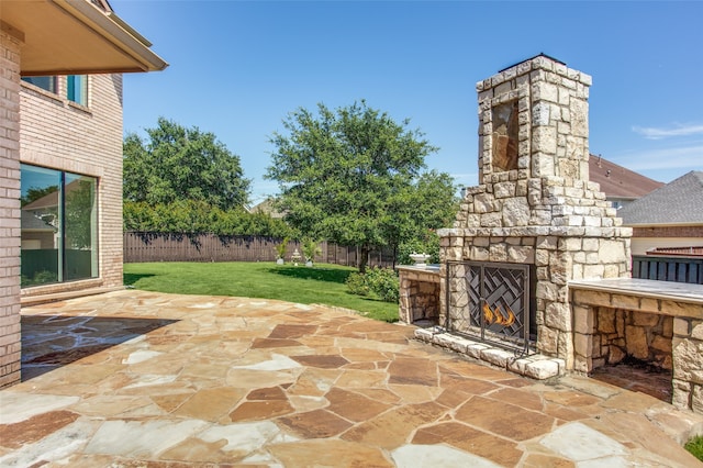 view of patio featuring an outdoor stone fireplace