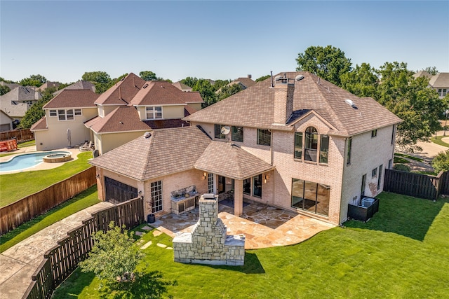 rear view of property with a lawn and a patio area