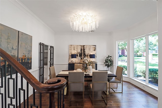 dining area featuring dark hardwood / wood-style flooring, crown molding, and a chandelier