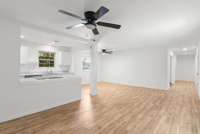 unfurnished living room with light hardwood / wood-style flooring, ceiling fan, and sink