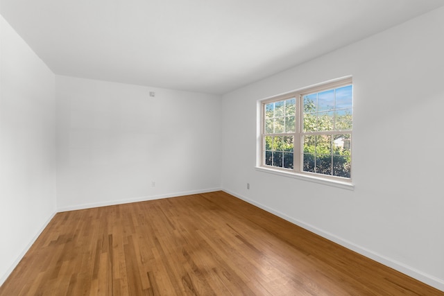 spare room with hardwood / wood-style flooring