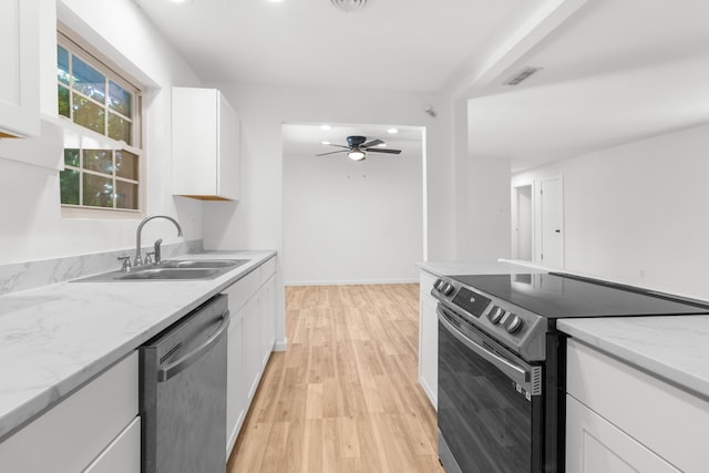 kitchen featuring light hardwood / wood-style floors, stainless steel appliances, sink, white cabinetry, and ceiling fan