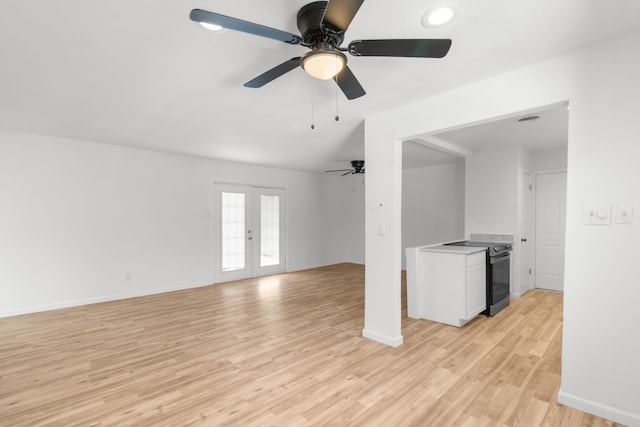 unfurnished living room with ceiling fan, light wood-type flooring, and french doors