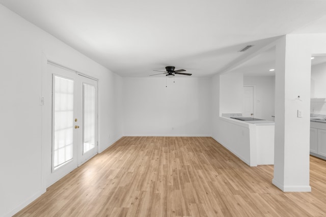 unfurnished living room featuring light hardwood / wood-style flooring and ceiling fan