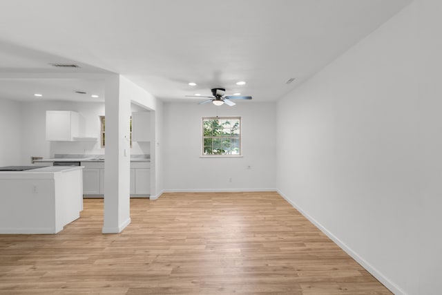 unfurnished living room featuring light wood-type flooring and ceiling fan