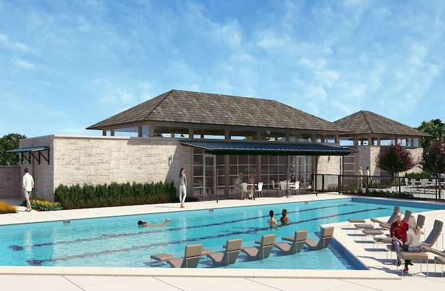 view of swimming pool featuring a patio and a sunroom