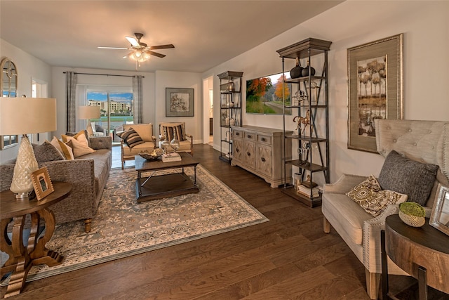 living room with dark wood-type flooring and ceiling fan