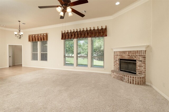 unfurnished living room with ornamental molding, a brick fireplace, ceiling fan, and carpet